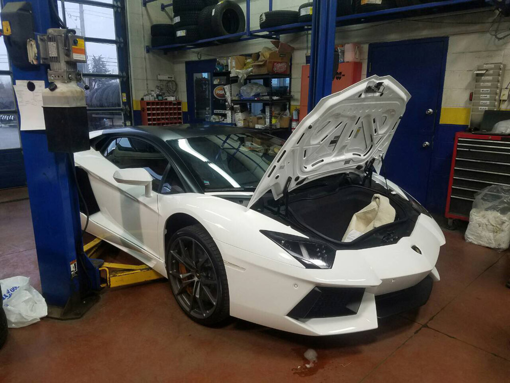 Lamborghini in an auto shop with hood open